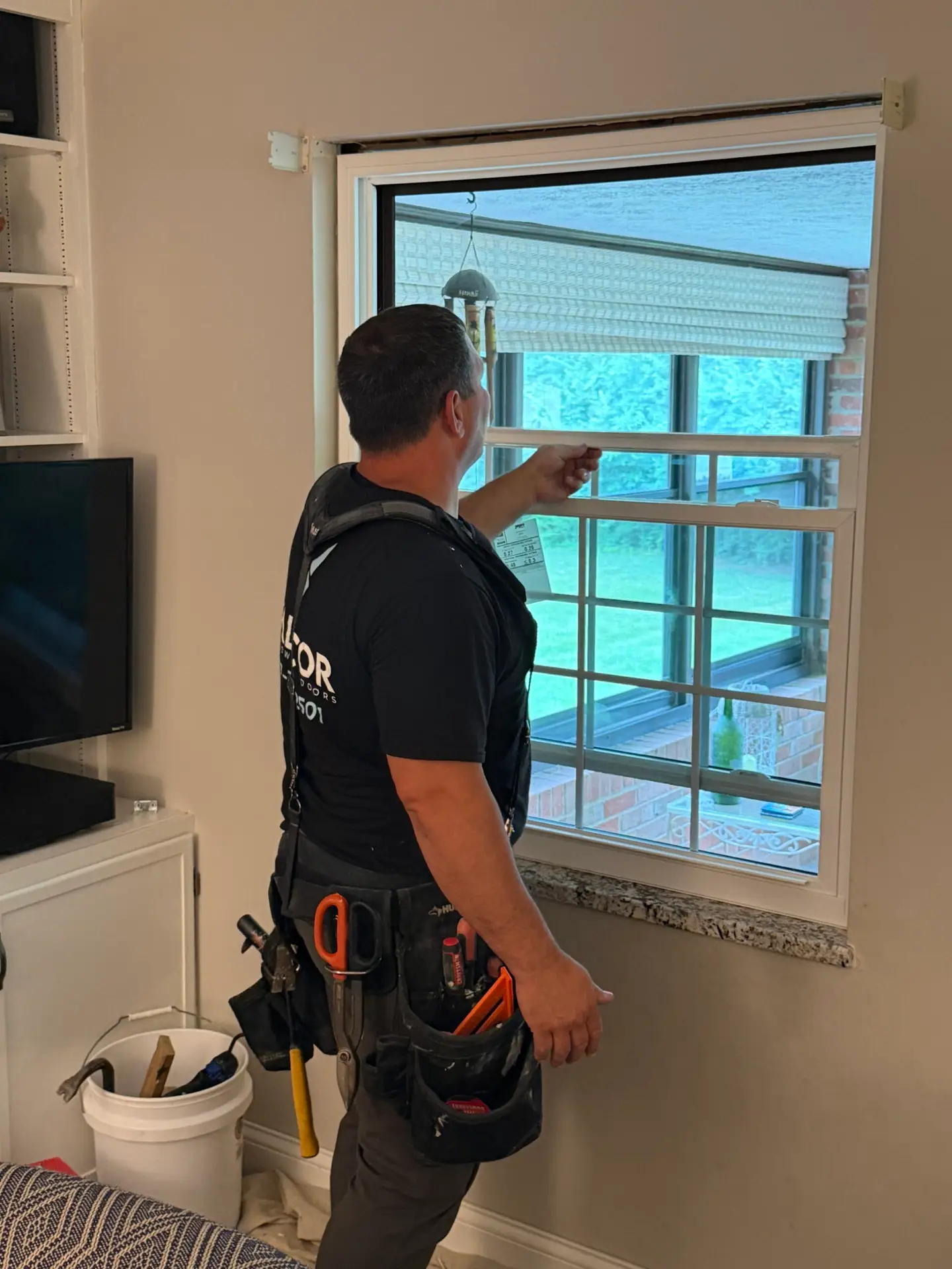 Replacement window during professional installation by Valicor Windows and Doors