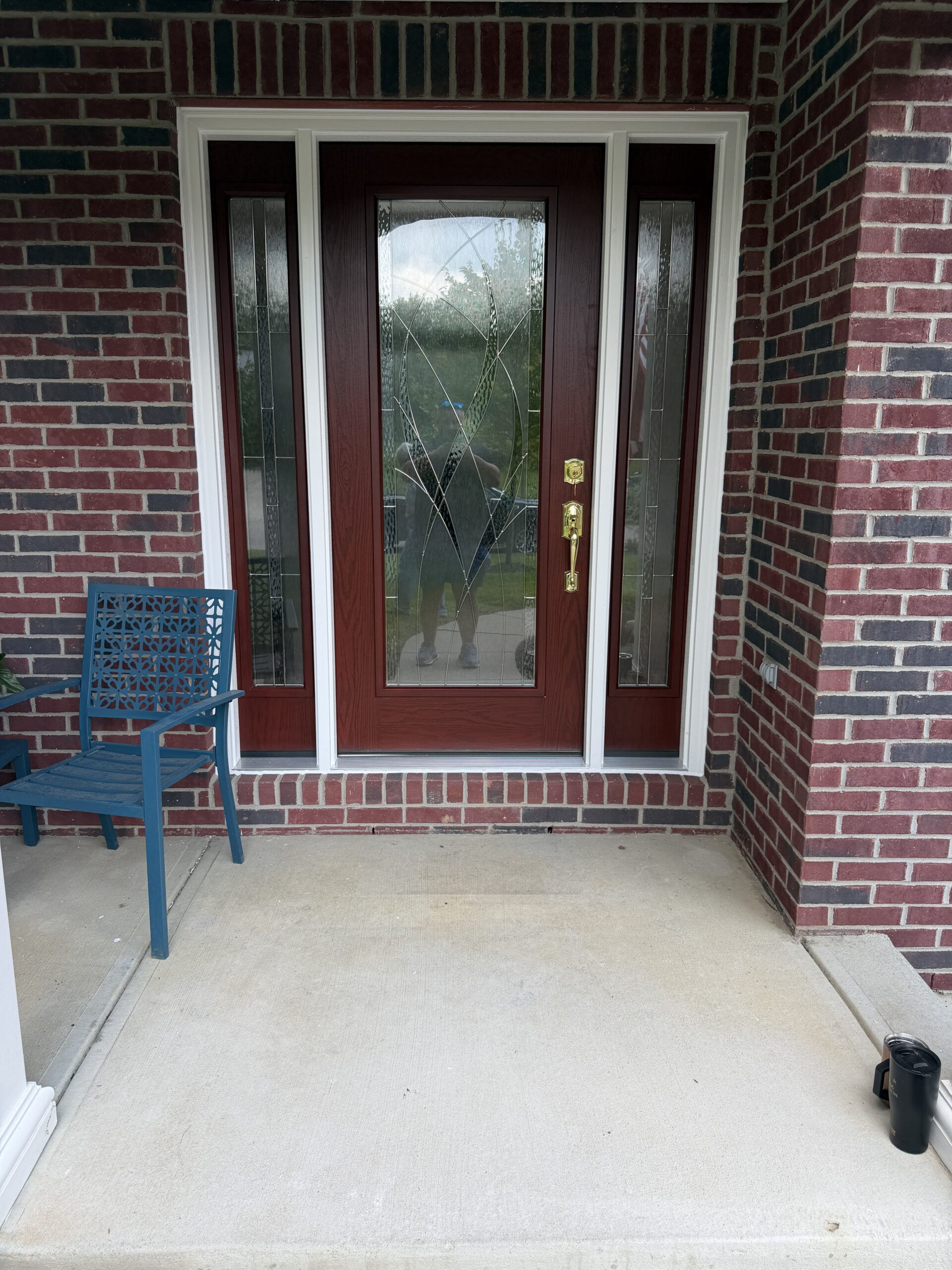 Cinnamon oak grain steel entry door installed on a Springboro Ohio home